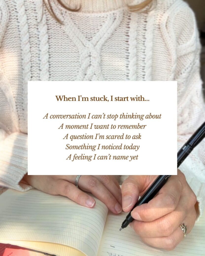 Man in swim trunks holds a baby in a blue life jacket in shallow water.