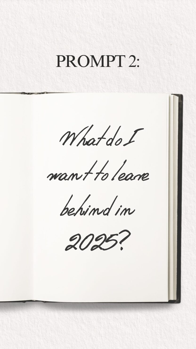 Man in swim trunks holds a baby in a blue life jacket in shallow water.