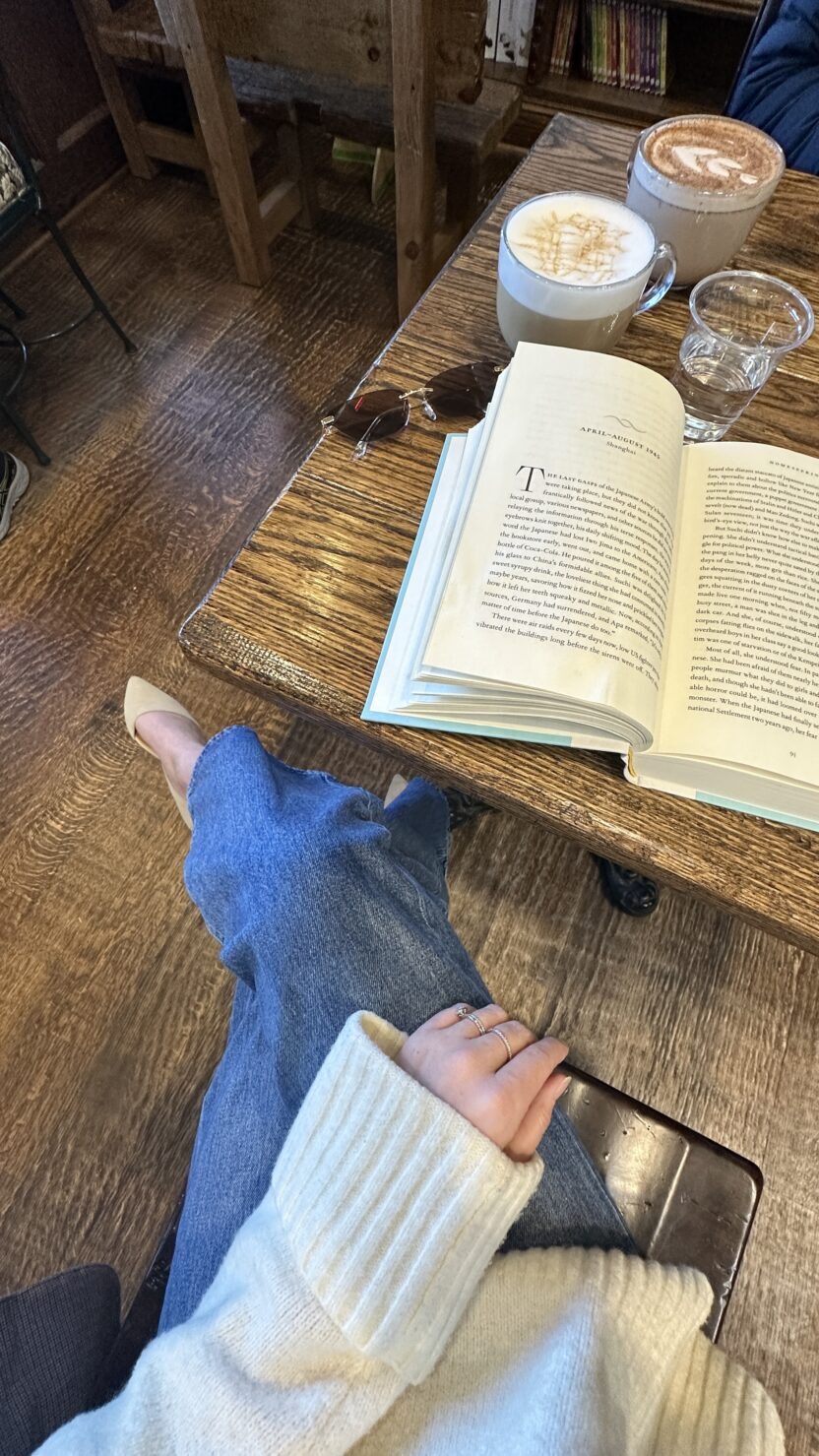flat lay of coffee and a b book on a table in a coffee shop